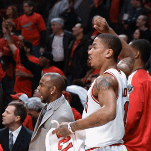 A Basketball Player Wearing A Number 10 Jersey Stands In Front Of A Crowd GIF