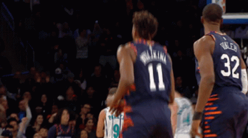 A Basketball Player Wearing A Number 11 Jersey Stands Next To A Player Wearing A Number 32 Jersey GIF