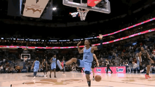A Basketball Player Wearing A Number 12 Jersey Is Jumping In The Air GIF