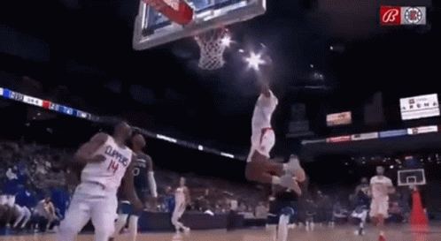 A Basketball Player Wearing A Number 14 Jersey Is Jumping In The Air While Playing Basketball . GIF