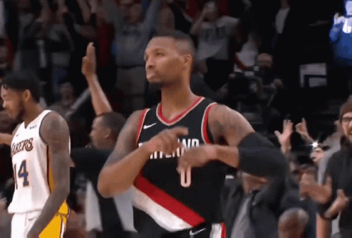 A Basketball Player Wearing A Number 14 Jersey Is Standing In Front Of A Crowd GIF