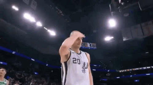 A Basketball Player Wearing A Number 20 Jersey Salutes During A Game GIF