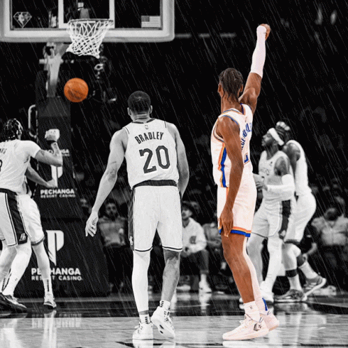 A Basketball Player Wearing A Number 20 Jersey Stands In The Rain GIF