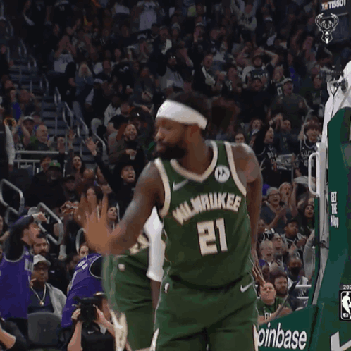 A Basketball Player Wearing A Number 21 Jersey GIF