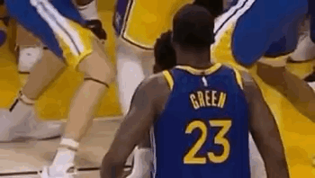 A Basketball Player Wearing A Number 23 Jersey Is Standing On A Court Surrounded By Other Players . GIF
