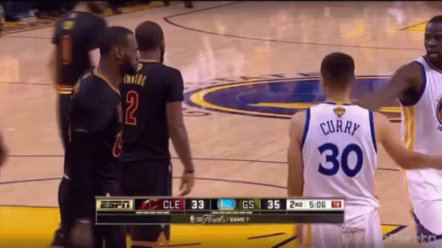 a basketball player wearing a number 30 jersey talks to another player