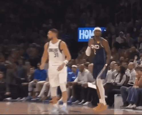 A Basketball Player Wearing A Number 31 Jersey Stands Next To A Player Wearing A Number 2 Jersey GIF