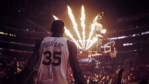A Basketball Player Wearing A Number 35 Jersey Stands In Front Of Fireworks GIF