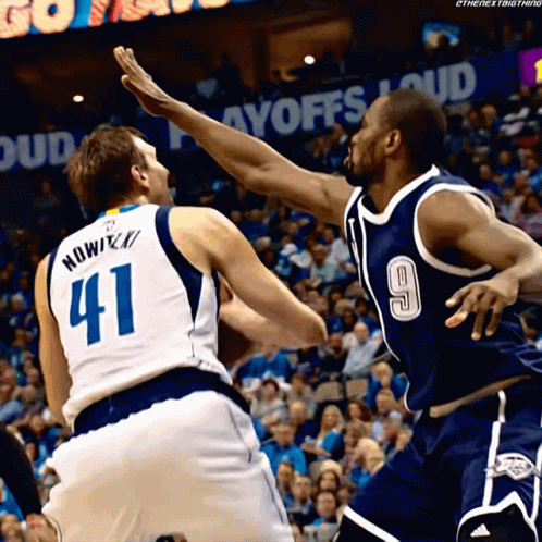 A Basketball Player Wearing A Number 41 Jersey Is Being Blocked By Another Player Wearing A Number 9 Jersey GIF
