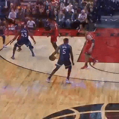 A Basketball Player Wearing A Number 5 Jersey Dribbles The Ball GIF
