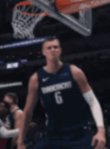 A Basketball Player Wearing A Number 6 Jersey Stands In Front Of A Basketball Net GIF