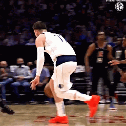 A Basketball Player Wearing A Number 7 Jersey Is Jumping In The Air GIF