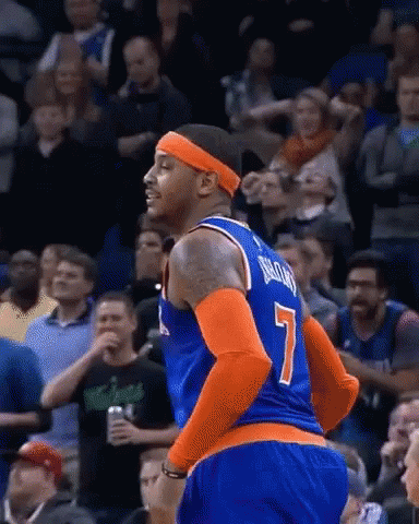A Basketball Player Wearing A Number 7 Jersey Is Standing In Front Of A Crowd . GIF