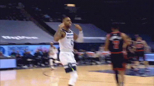 A Basketball Player Wearing A Number 7 Jersey Runs Towards Another Player GIF