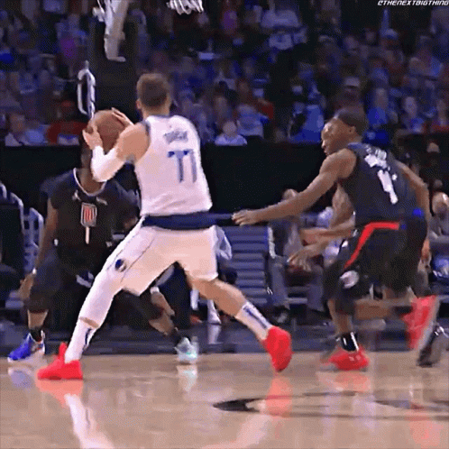 A Basketball Player Wearing A Number 77 Jersey Dribbles The Ball GIF