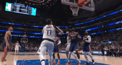 A Basketball Player Wearing A Number 77 Jersey Is Jumping In The Air GIF