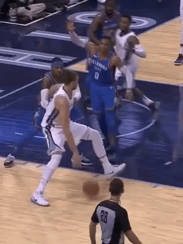 A Basketball Player Wearing A Number 8 Jersey Dribbles The Ball GIF