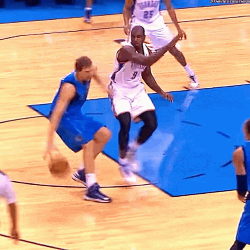 A Basketball Player Wearing A Number 9 Jersey Dribbles The Ball GIF