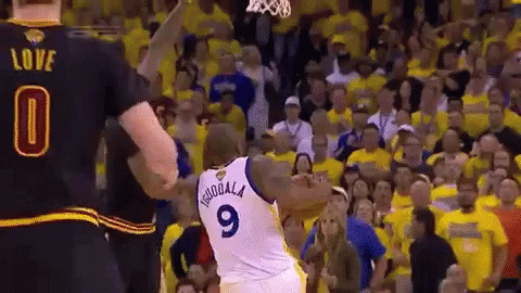 A Basketball Player Wearing A Number 9 Jersey Stands In Front Of A Crowd GIF