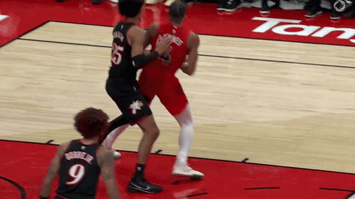 a basketball player wearing a number 9 jersey stands on the court