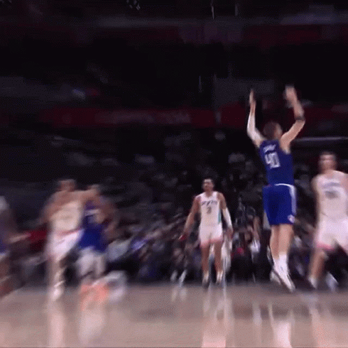A Basketball Player Wearing A Number 90 Jersey Jumps In The Air GIF