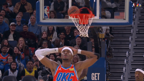 A Basketball Player Wearing A Oklahoma City Thunder Jersey Is About To Dunk The Ball GIF