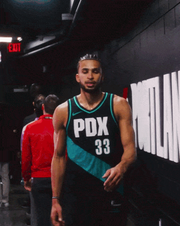 A Basketball Player Wearing A Pdx 33 Jersey Walks Down A Hallway GIF