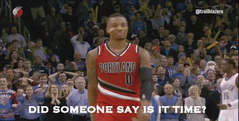 a basketball player wearing a portland jersey is standing in front of a crowd