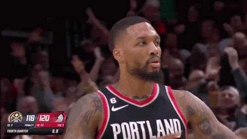 A Basketball Player Wearing A Portland Jersey Stands In Front Of The Crowd GIF