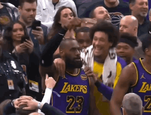 A Basketball Player Wearing A Purple Lakers Jersey Is Surrounded By Fans GIF
