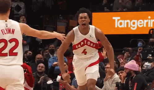 A Basketball Player Wearing A Raptors Jersey Celebrates GIF