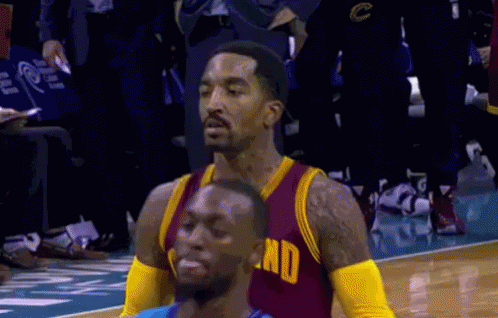 A Basketball Player Wearing A Red And Gold Jersey With The Word End On The Front GIF