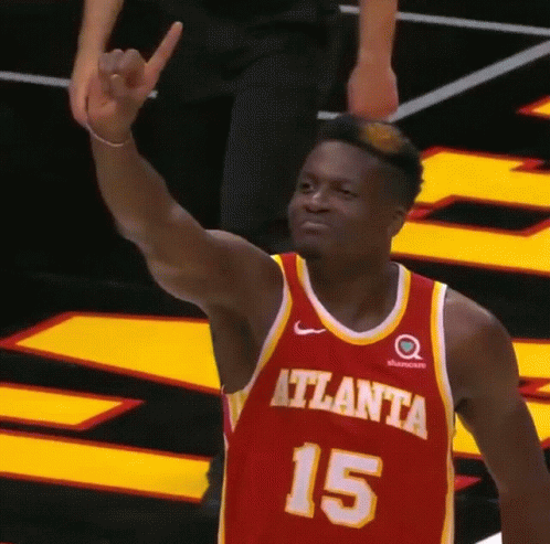 A Basketball Player Wearing A Red And Yellow Jersey With The Number 15 On It GIF