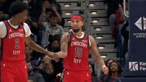 A Basketball Player Wearing A Red Jersey That Says Crescent City Shakes Hands With Another Player GIF