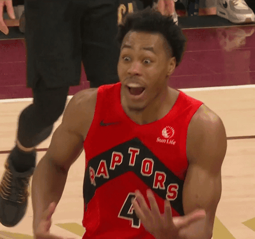 a basketball player wearing a red jersey that says raptors