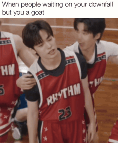 a basketball player wearing a red jersey that says rhythm 23