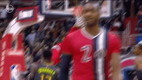 A Basketball Player Wearing A Red Jersey With The Number 2 On It Stands In Front Of A Crowd . GIF