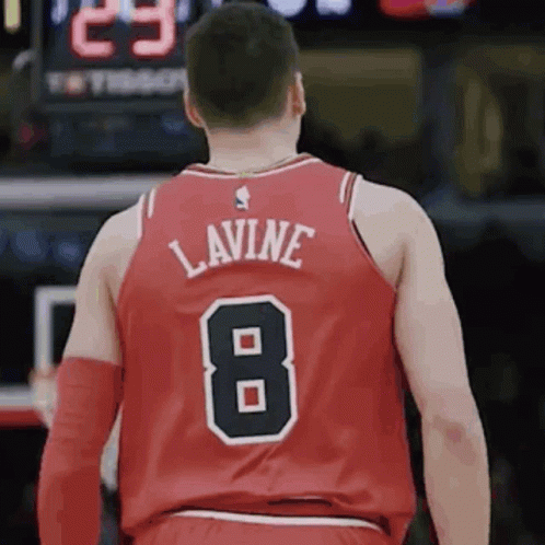 A Basketball Player Wearing A Red Jersey With The Number 8 On The Back GIF
