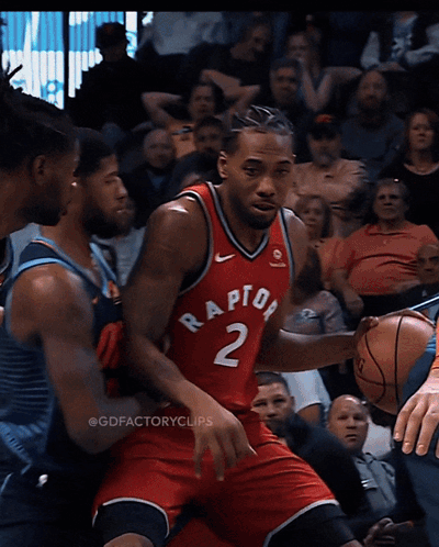 A Basketball Player Wearing A Red Raptors Jersey Is Dribbling The Ball GIF