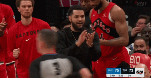 A Basketball Player Wearing A Red Raptors Jersey GIF