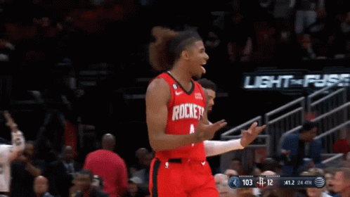 A Basketball Player Wearing A Red Rockets Jersey Celebrates GIF