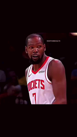 A Basketball Player Wearing A Rockets Jersey Looks At The Camera GIF