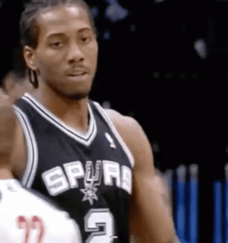 A Basketball Player Wearing A Spurs Jersey Is Standing Next To Another Player On The Court . GIF