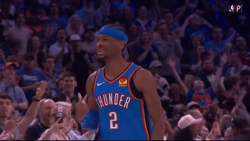 A Basketball Player Wearing A Thunder Jersey Is Standing In Front Of A Crowd Of People . GIF