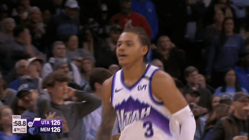 A Basketball Player Wearing A Utah Jersey Stands In Front Of A Crowd GIF