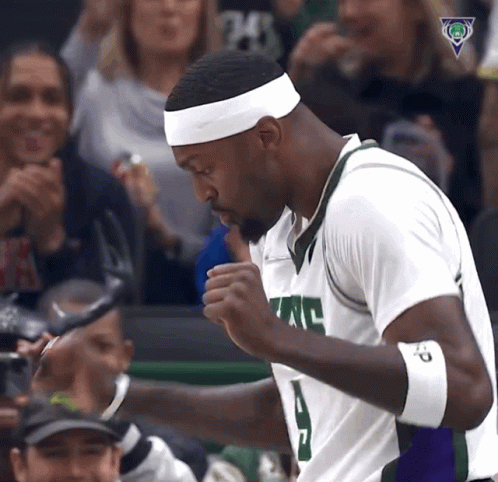 A Basketball Player Wearing A White Headband With The Number 24 On It Stands In Front Of A Crowd GIF