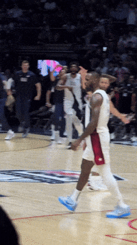A Basketball Player Wearing A White Jersey And Red Shorts GIF