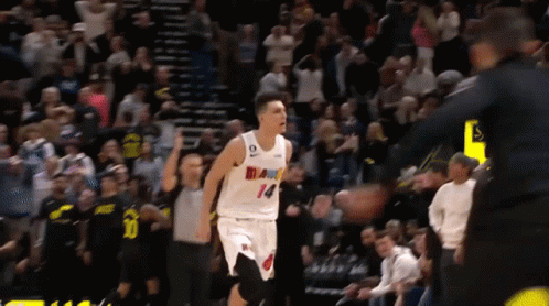 A Basketball Player Wearing A White Jersey With Miami On It GIF