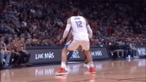 A Basketball Player Wearing A White Jersey With The Number 12 On It GIF