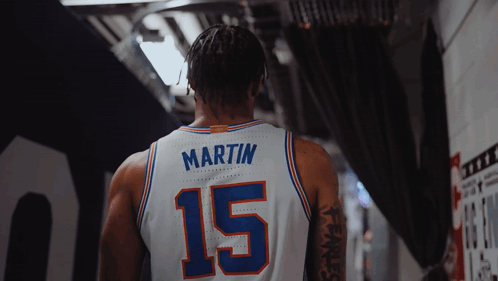 a basketball player wearing a white jersey with the number 15 on it